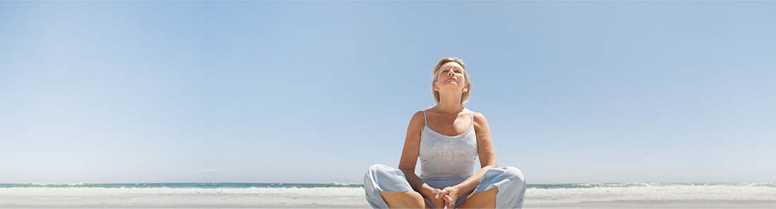 image of woman sitting on beach
